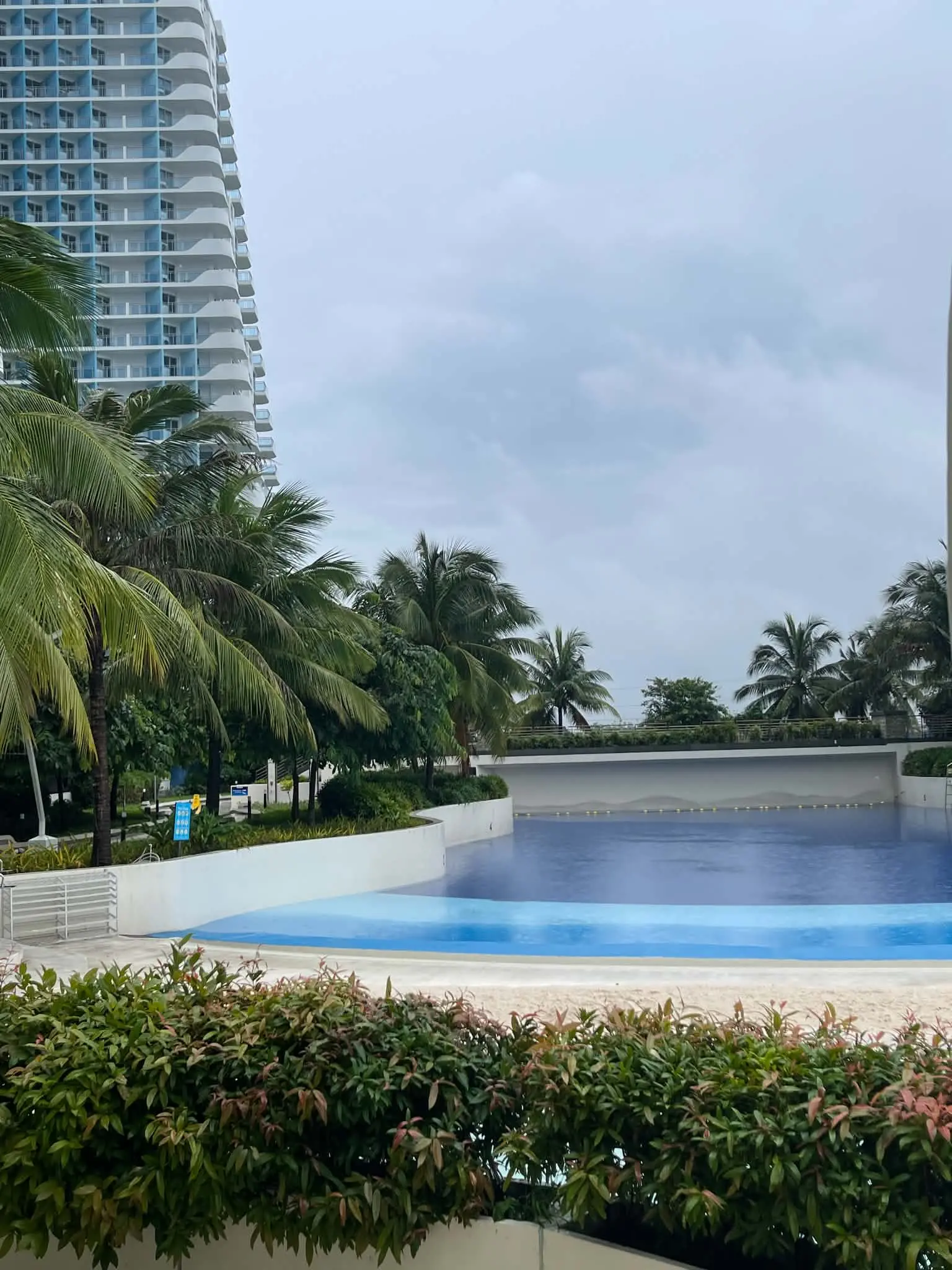 Azure North resort-style lagoon pool with beach entry and palm trees